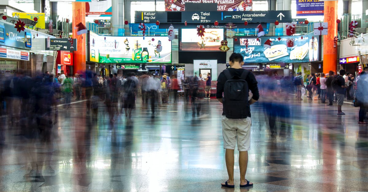 Is eating permitted in La Guardia airport airport nowadays? - Man in Black Jacket and Beige Pants Walking on Gray Floor Tiles Is eating permitted in La Guardia airport airport nowadays? - Man in Black Jacket and Beige Pants Walking on Gray Floor Tiles