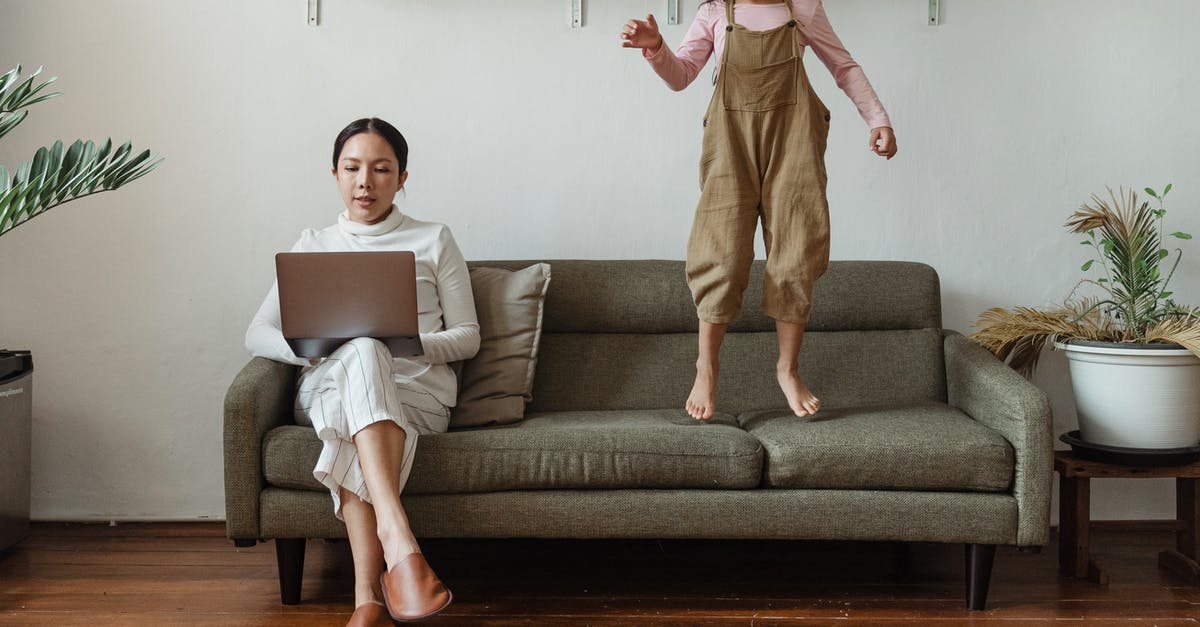 Is historic downtown in Savannah, GA too loud for kids to stay over night? - Focused mother working on laptop near disturbing daughter Is historic downtown in Savannah, GA too loud for kids to stay over night? - Focused mother working on laptop near disturbing daughter