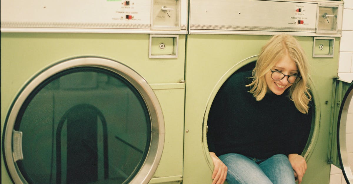 Is it a reasonable assumption that larger US hotels will have laundry facilities? - Cheerful woman sitting in laundry machine Is it a reasonable assumption that larger US hotels will have laundry facilities? - Cheerful woman sitting in laundry machine