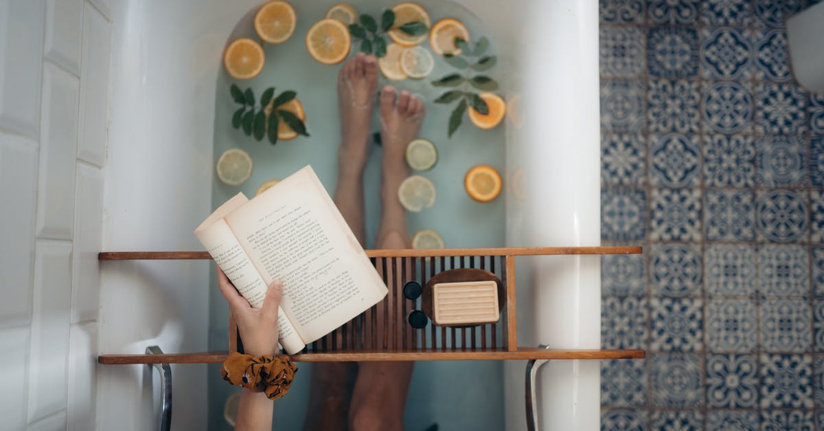 Is it allowed to bathe at Grjótagjá? - Person Holding Book Page on White Table