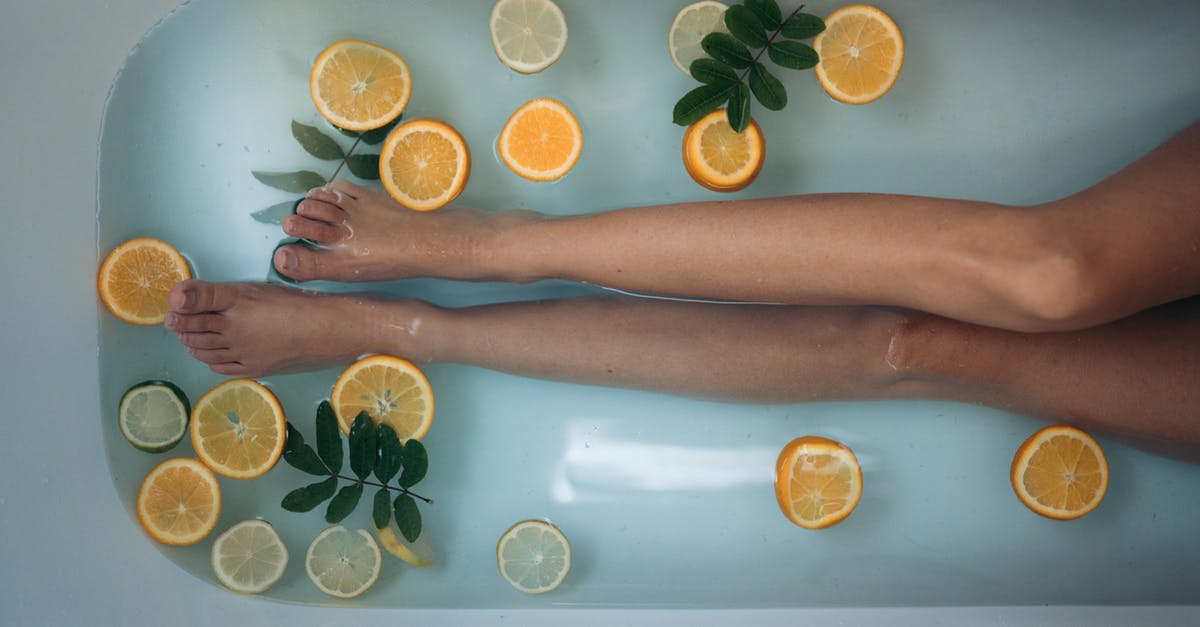 Is it allowed to bathe at Grjótagjá? - Person Holding Sliced Orange Fruit