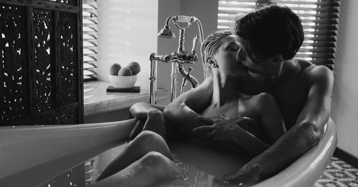 Is it allowed to bathe at Grjótagjá? - Couple Kissing while Sitting on Bathtub