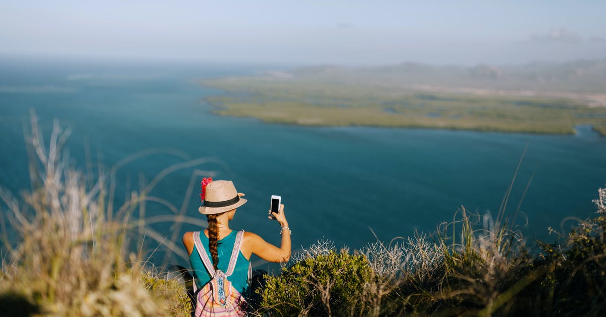 Is it allowed to mount GPS/smartphone on windscreen in Switzerland? If so, how? - Back view of unrecognizable female traveler taking photo of foggy ocean on cellphone while resting on grass mount Is it allowed to mount GPS/smartphone on windscreen in Switzerland? If so, how? - Back view of unrecognizable female traveler taking photo of foggy ocean on cellphone while resting on grass mount