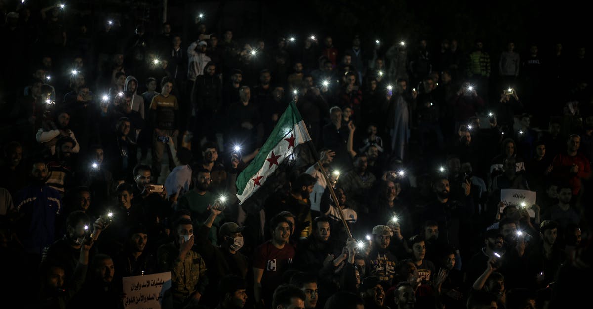 Is it allowed to spend a night in the first entry country before moving to the main destination? - Crowd of people in protest on street Is it allowed to spend a night in the first entry country before moving to the main destination? - Crowd of people in protest on street