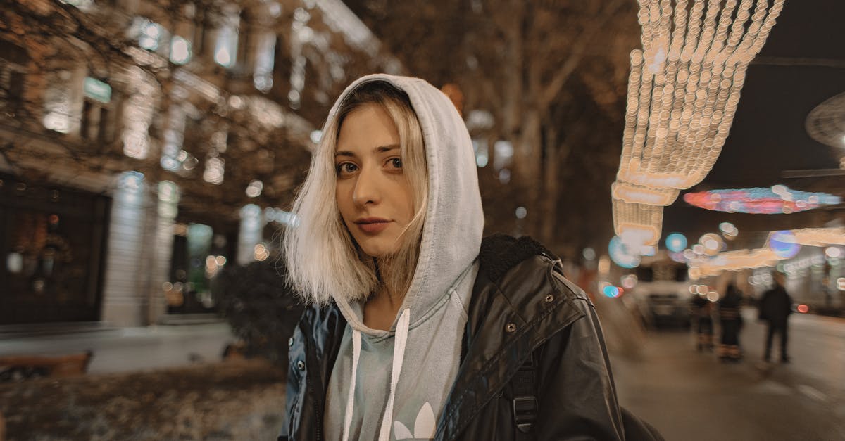Is it cold enough in England/London to have to wear a woolen/winter hat? [closed] - Close-up Of A Woman Wearing Black Zip-up Jacket Over A Gray Hoodie