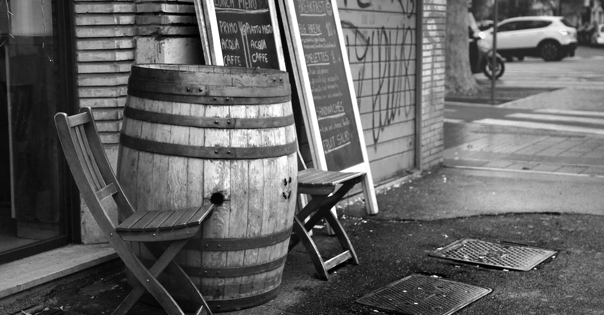 Is it feasible to do a Monopoly board pub crawl in London? - Black and white wooden barrel and chairs placed outside coffee shop near menu chalkboard