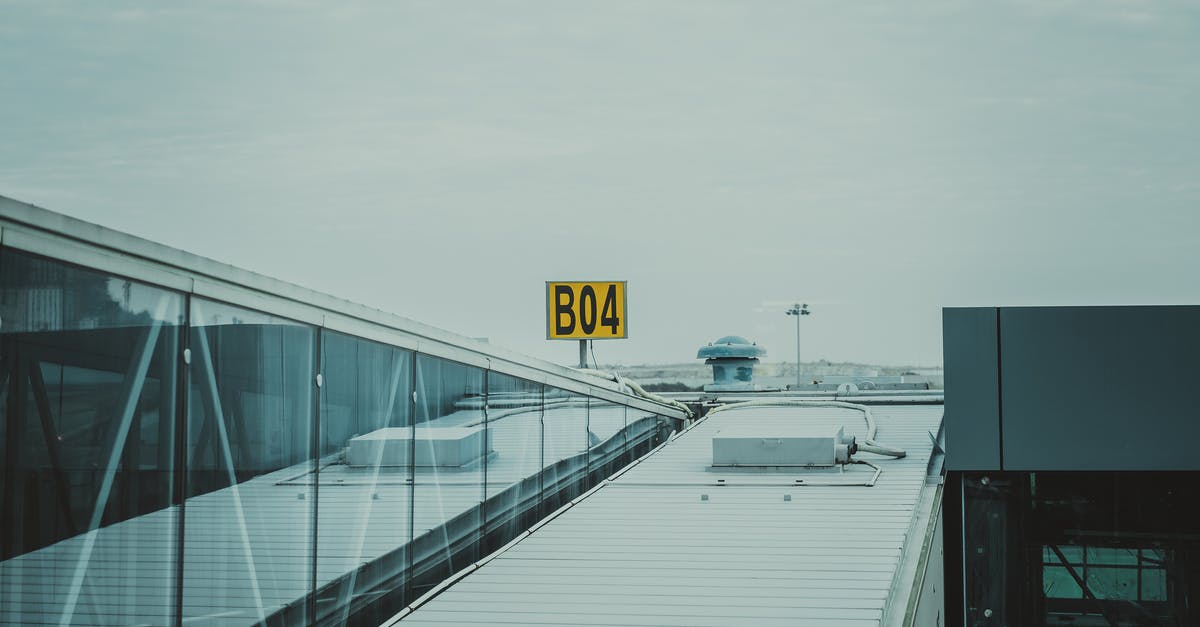 Is it legal for airport officers to ask someone to remove their jeans if they're setting of metal detectors? - White Metal Roof Under White Sky Is it legal for airport officers to ask someone to remove their jeans if they're setting of metal detectors? - White Metal Roof Under White Sky