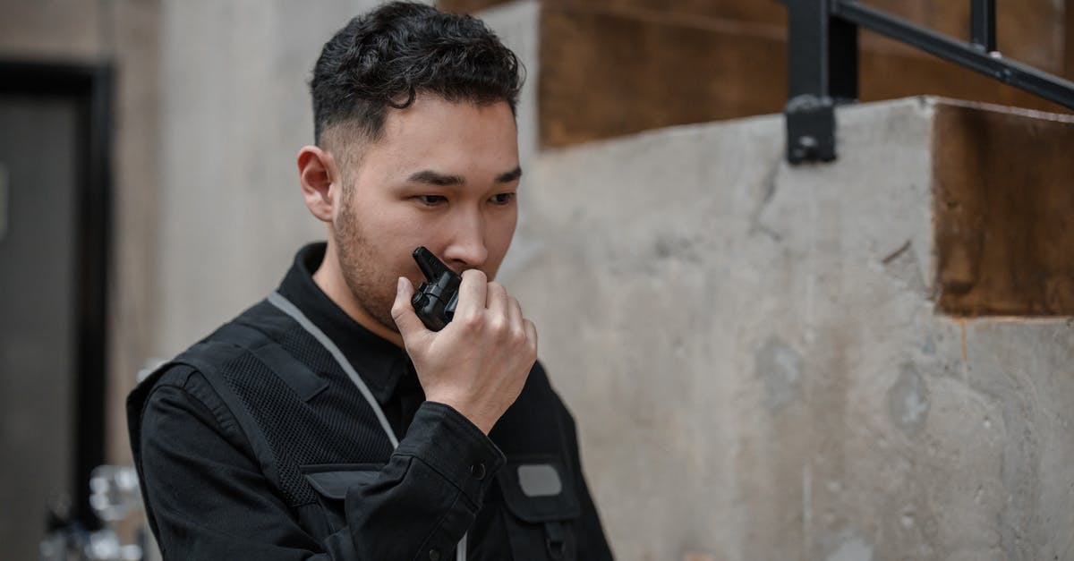 Is it legal in Spain for a male airport security guard to ask you to lift up your blouse and swab your bare stomach? - A Man Talking on a Walkie Talkie 