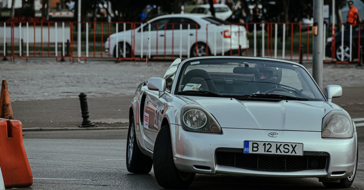 Is it legal to turn high beams on when driving on a European highway with fully separated lanes? - Silver cabriolet car racing in urban rally and driving on asphalt roadway in city Is it legal to turn high beams on when driving on a European highway with fully separated lanes? - Silver cabriolet car racing in urban rally and driving on asphalt roadway in city