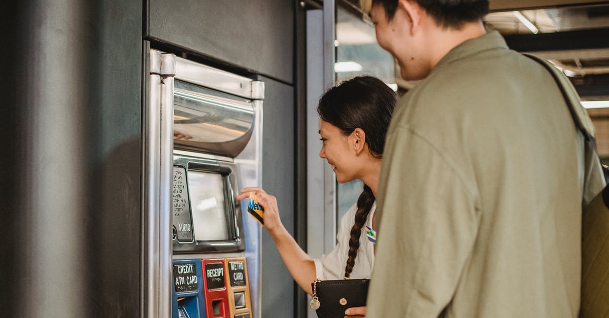 Is it necessary to buy Disneyland Paris tickets in advance? - Content couple using ticket machine in underground Is it necessary to buy Disneyland Paris tickets in advance? - Content couple using ticket machine in underground