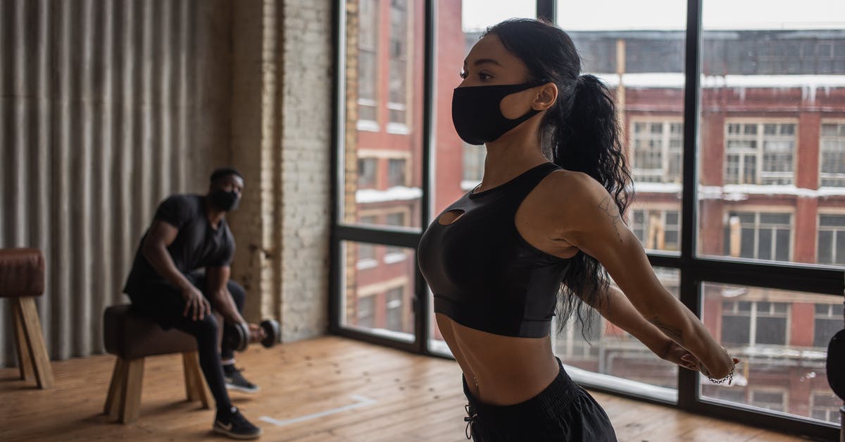Is it normal practice to tip an Uber driver in London? - Fit African American sportswoman in mask stretching arms while training in gym during coronavirus pandemic with man lifting dumbbell Is it normal practice to tip an Uber driver in London? - Fit African American sportswoman in mask stretching arms while training in gym during coronavirus pandemic with man lifting dumbbell