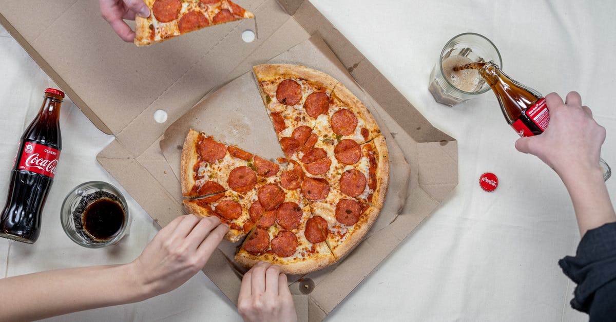 Is it not appropriate to eat pizza with hands in Germany? - Person Pouring A Drink Into A Glass Is it not appropriate to eat pizza with hands in Germany? - Person Pouring A Drink Into A Glass
