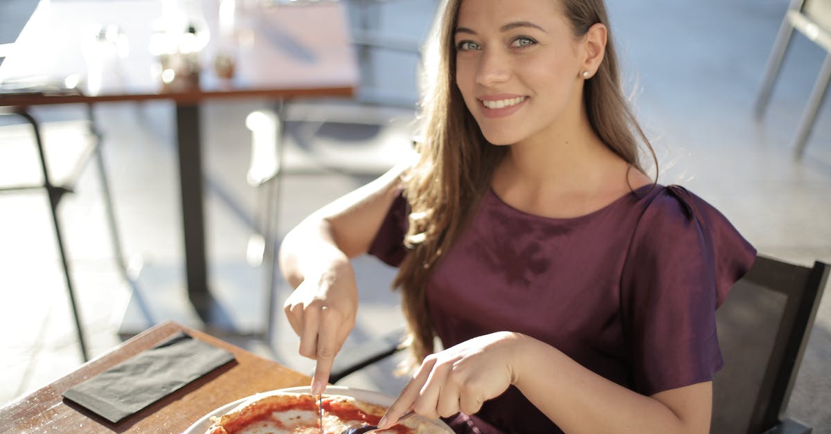 Is it not appropriate to eat pizza with hands in Germany? - Woman in Purple Top Eating Pizza Is it not appropriate to eat pizza with hands in Germany? - Woman in Purple Top Eating Pizza