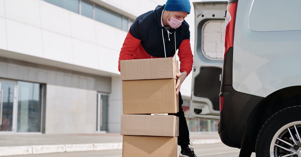 Is it OK to check in a box that is not plain on the outside (e.g. there are printed pictures, etc. on the box) - Delivery Man Wearing a Face Mask Carrying Boxes Is it OK to check in a box that is not plain on the outside (e.g. there are printed pictures, etc. on the box) - Delivery Man Wearing a Face Mask Carrying Boxes