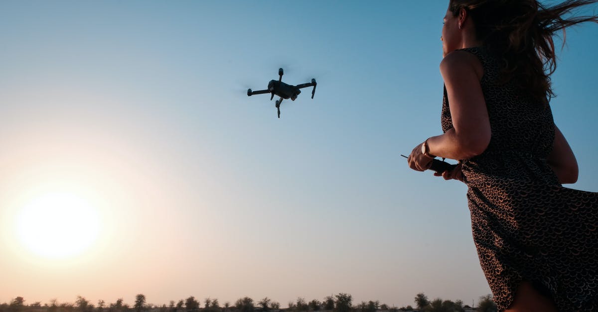 Is it OK to dress as a stewardess on a flight? - Woman Holding Remote of Drone Is it OK to dress as a stewardess on a flight? - Woman Holding Remote of Drone