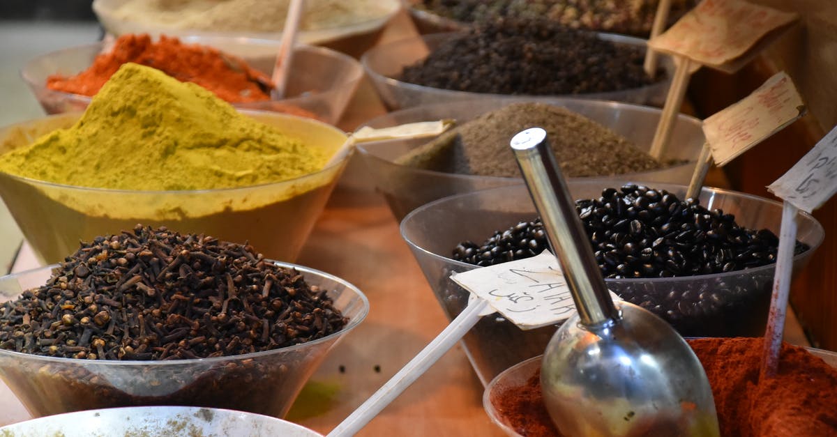 Is it okay to mix in local language when I know it poorly? - From above of bowls full of various dry seasonings on table in street bazaar Is it okay to mix in local language when I know it poorly? - From above of bowls full of various dry seasonings on table in street bazaar