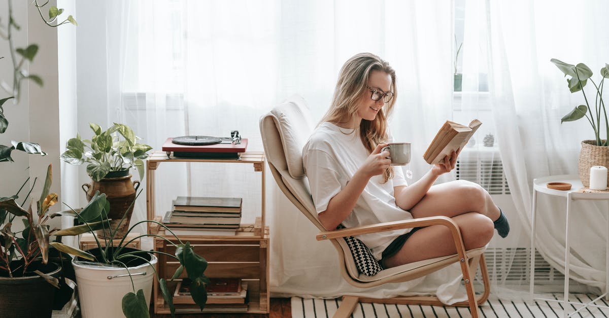 Is it okay to order a pot of tea in Australia and ask for an extra cup? - Cheerful young female in eyeglasses with cup of beverage reading textbook in armchair between potted plants in house room Is it okay to order a pot of tea in Australia and ask for an extra cup? - Cheerful young female in eyeglasses with cup of beverage reading textbook in armchair between potted plants in house room