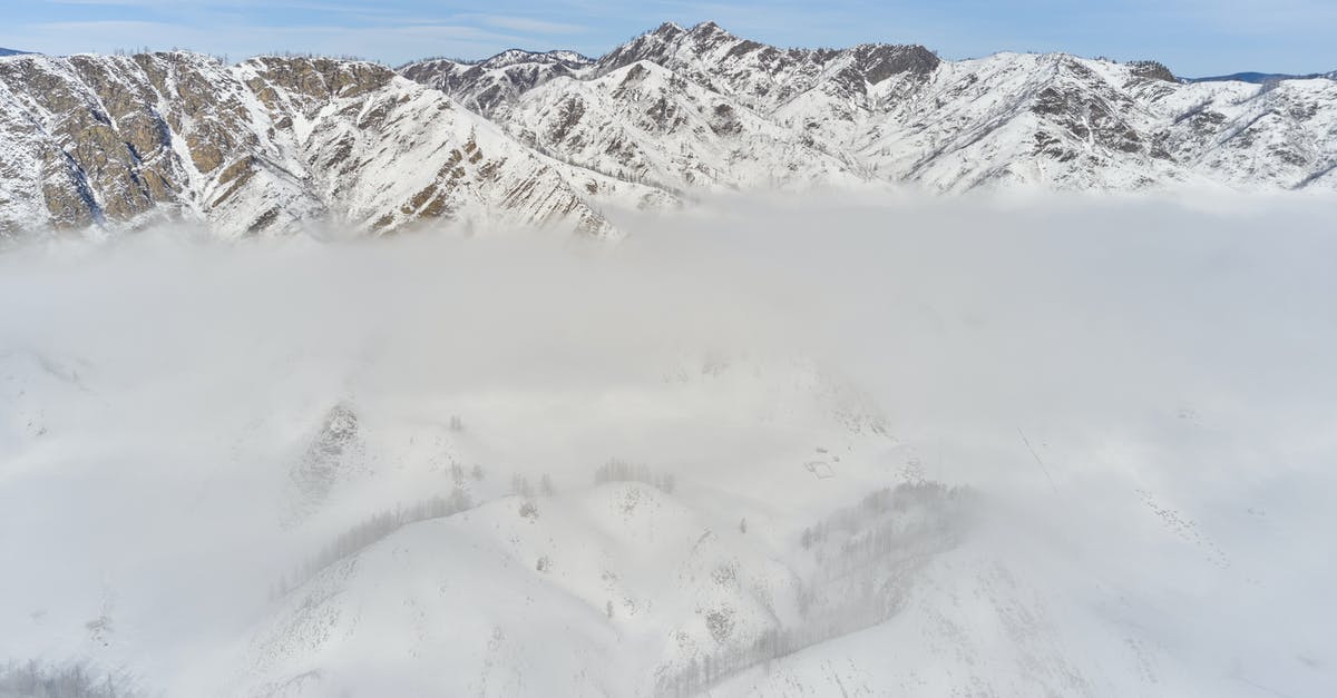 Is it okay to stay an extra day than my Schengen visa validity if I pass through immigration before midnight? [duplicate] - Snowy mountain ridge through clouds at sunny day