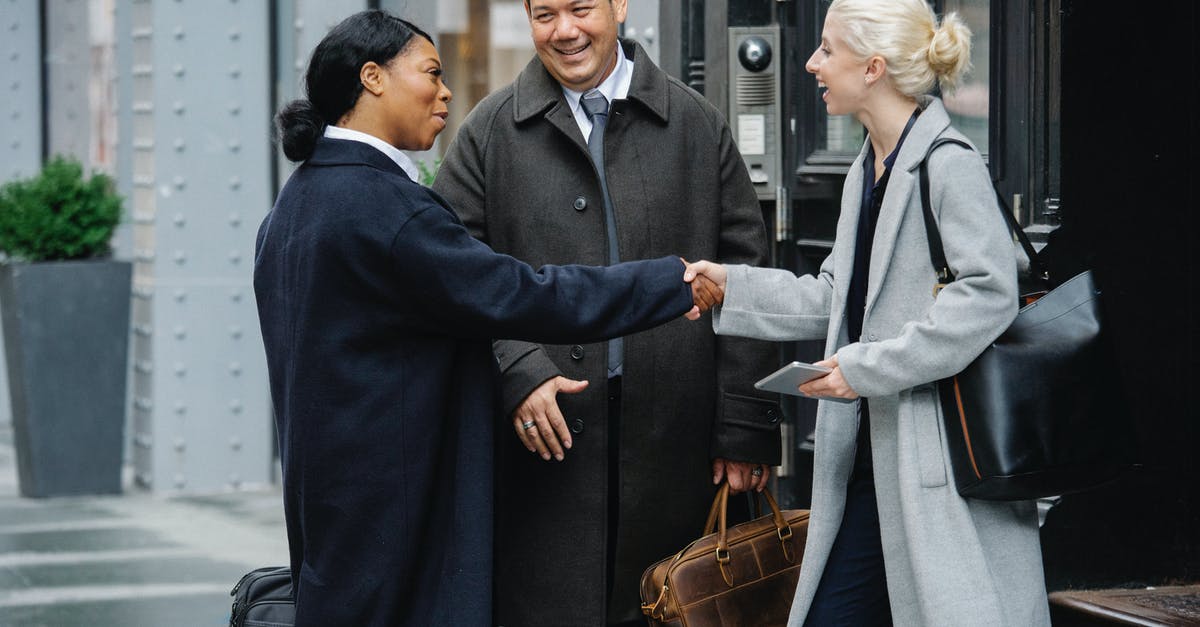 Is it possible for a foreign employee to subscribe to a smartphone contract plan in Kazakhstan? [closed] - Positive diverse colleagues shaking hands after meeting on street