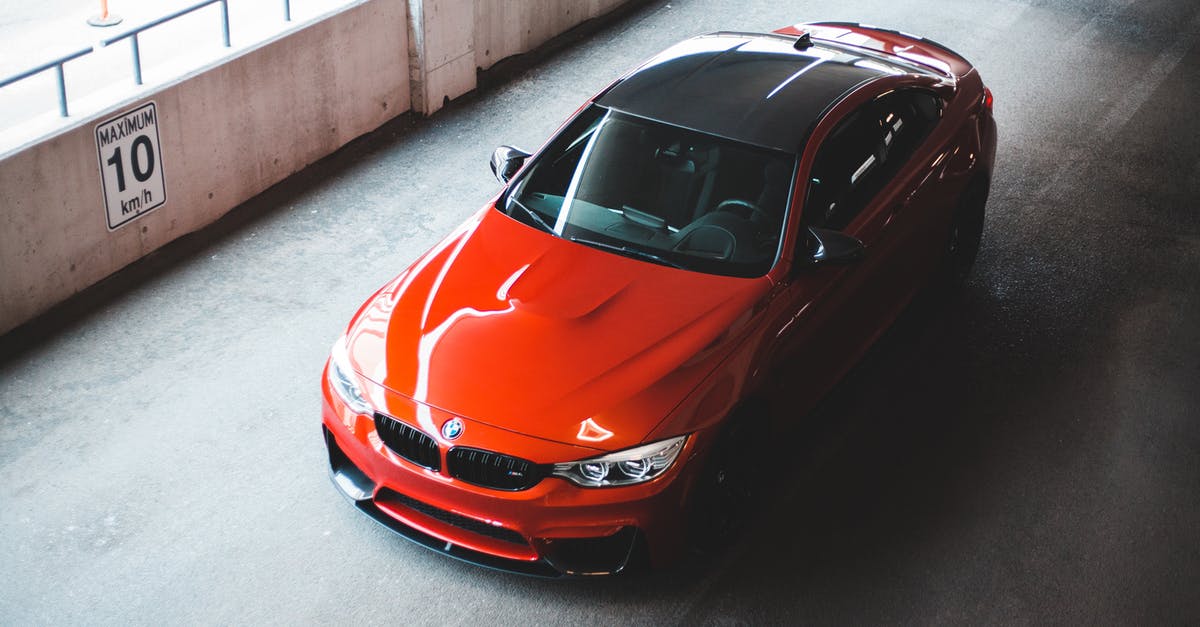 Is it possible for Indian citizen to visit Australia on tourist visa and buy new car and drive from Adelaide to cairns? - From above of sport modern automobile with red and black elements on parking road