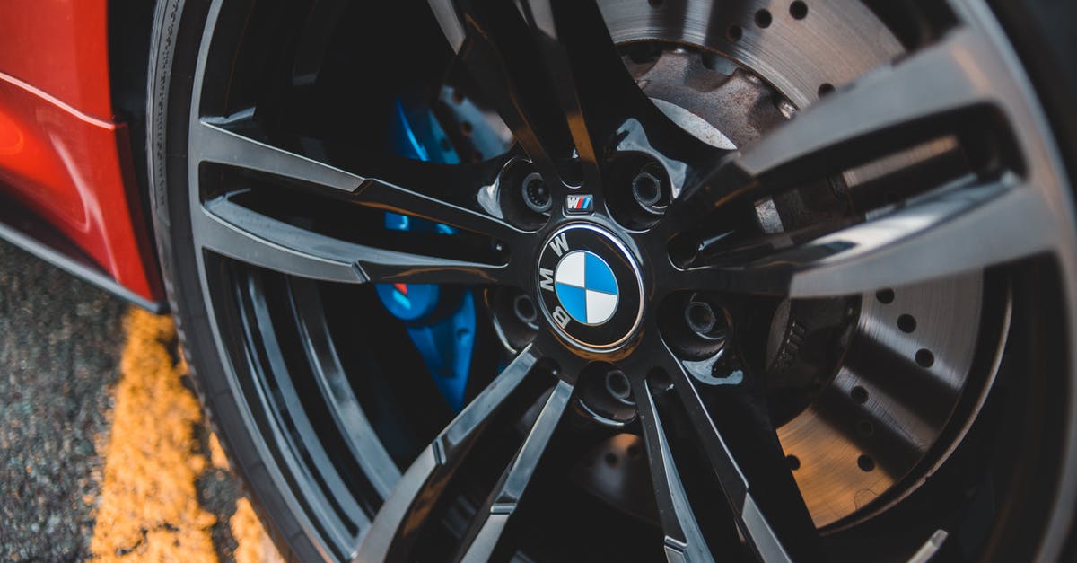 Is it possible for Indian citizen to visit Australia on tourist visa and buy new car and drive from Adelaide to cairns? - From above modern red auto wheel metal rim with shiny lug nuts on asphalt road with marking line
