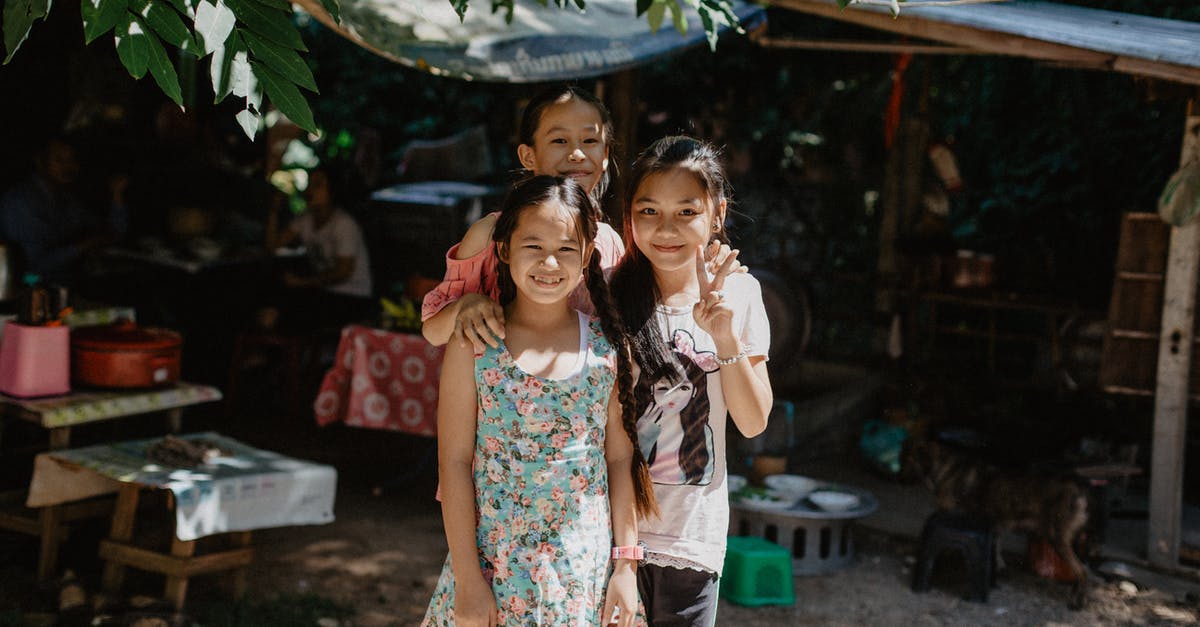 Is it possible to achieve 4G/LTE environment without buying local SIM? - Happy ethnic little girls smiling and looking at camera while standing together on street of village Is it possible to achieve 4G/LTE environment without buying local SIM? - Happy ethnic little girls smiling and looking at camera while standing together on street of village