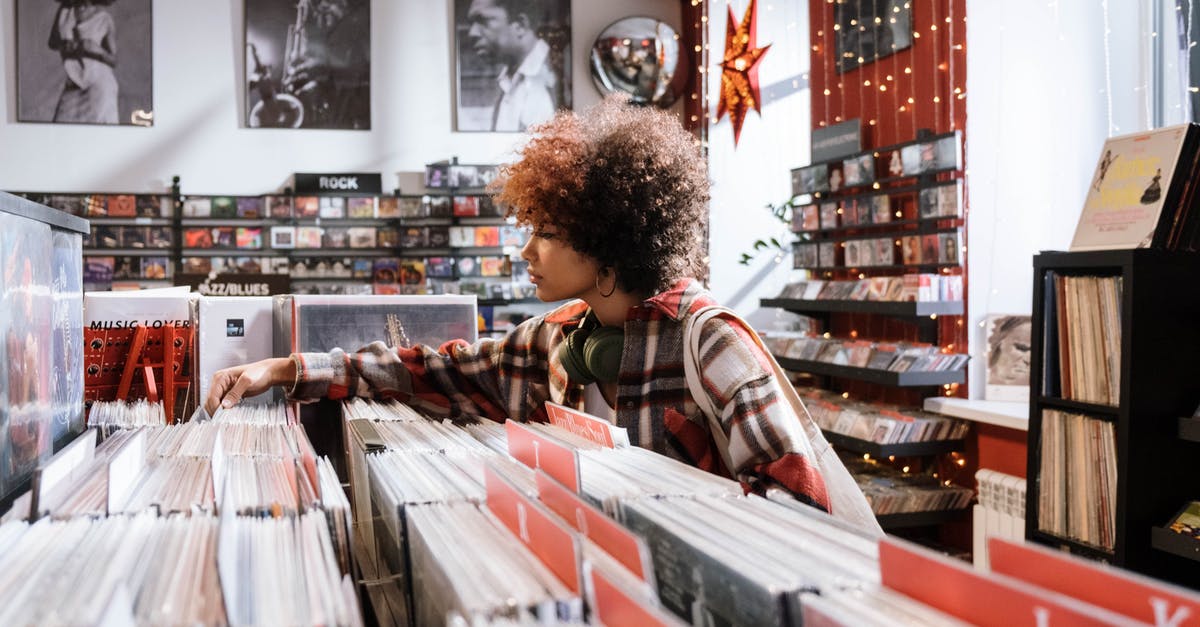 Is it possible to avoid getting an Israeli passport stamp? - Woman in Red and White Plaid Shirt Standing in Front of Books Is it possible to avoid getting an Israeli passport stamp? - Woman in Red and White Plaid Shirt Standing in Front of Books