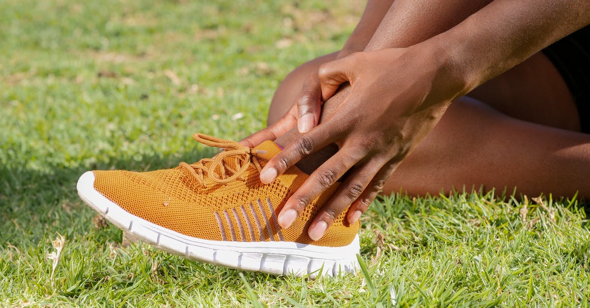 Is it possible to avoid removing my shoes if doing so will interfere with a supportive ankle brace? - A Person Touching His Ankle Is it possible to avoid removing my shoes if doing so will interfere with a supportive ankle brace? - A Person Touching His Ankle