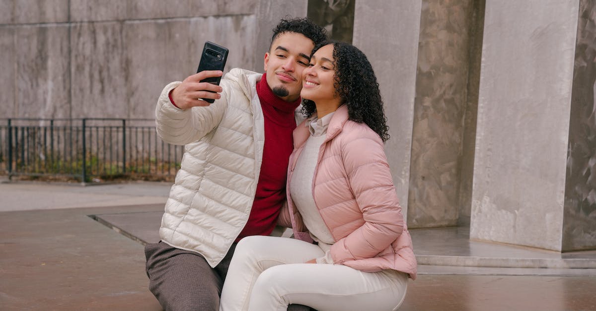 Is it possible to change date of a connection? - Delighted young ethnic couple touching cheeks while taking selfie sitting on parapet Is it possible to change date of a connection? - Delighted young ethnic couple touching cheeks while taking selfie sitting on parapet