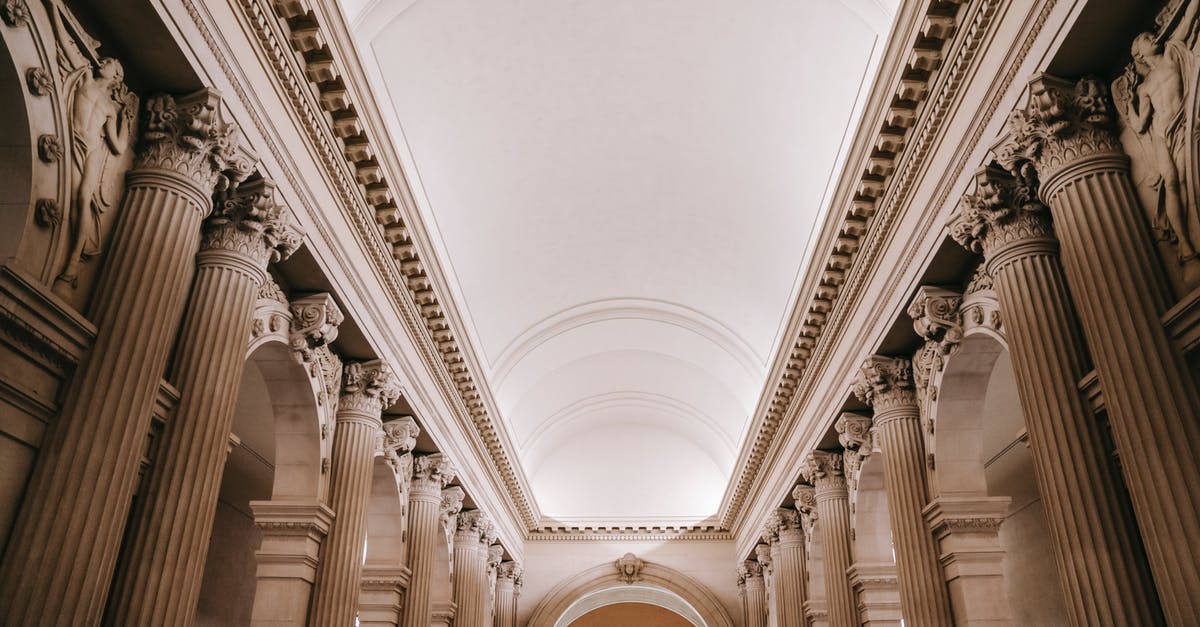 Is it possible to check in at the gate or the transit hall at Cochin? - Interior of grand classic palace passage with majestic stone colonnade beneath arched white ceiling and ornamental stucco works Is it possible to check in at the gate or the transit hall at Cochin? - Interior of grand classic palace passage with majestic stone colonnade beneath arched white ceiling and ornamental stucco works