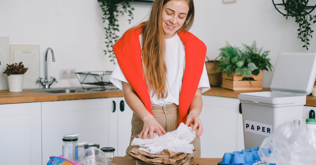 Is it possible to check-in a small bag which is usually used as a cabin bags? - Smiling woman stacking paper litter for reuse Is it possible to check-in a small bag which is usually used as a cabin bags? - Smiling woman stacking paper litter for reuse
