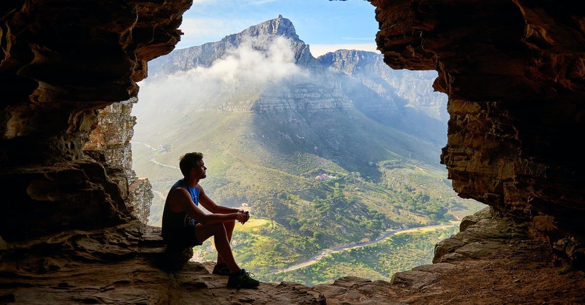 Is it possible to climb Uluru (Ayers Rock)? - Photo of Man Sitting on a Cave Is it possible to climb Uluru (Ayers Rock)? - Photo of Man Sitting on a Cave