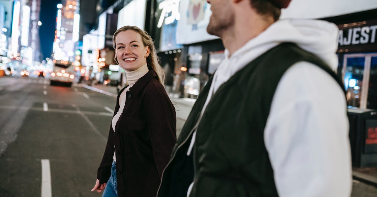 Is it possible to cross the Wagan border by car? - Side view of crop unrecognizable coworkers in formal wear with leather briefcase crossing urban road