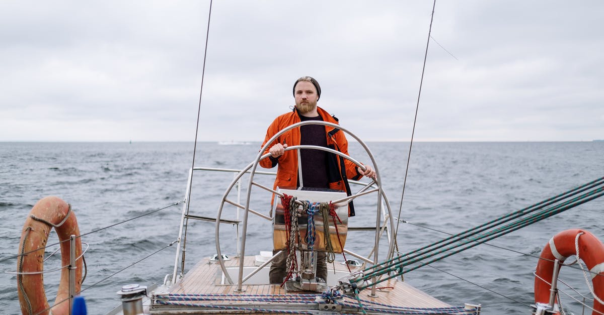 Is it possible to drive to Hawaii? - Man in Orange Jacket Sailing on a Boat Is it possible to drive to Hawaii? - Man in Orange Jacket Sailing on a Boat