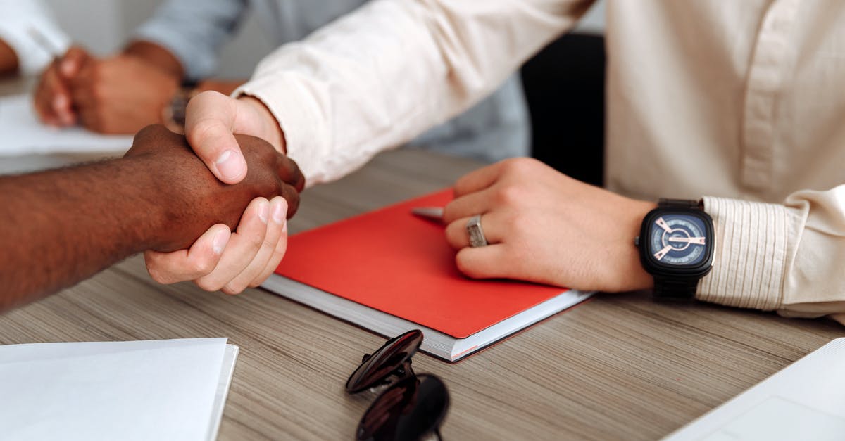 Is it possible to get an immigration visa (to stay as long as possible) to US while working remotely for a company in another country? [closed] - Close-up Photo of People Doing Handshake