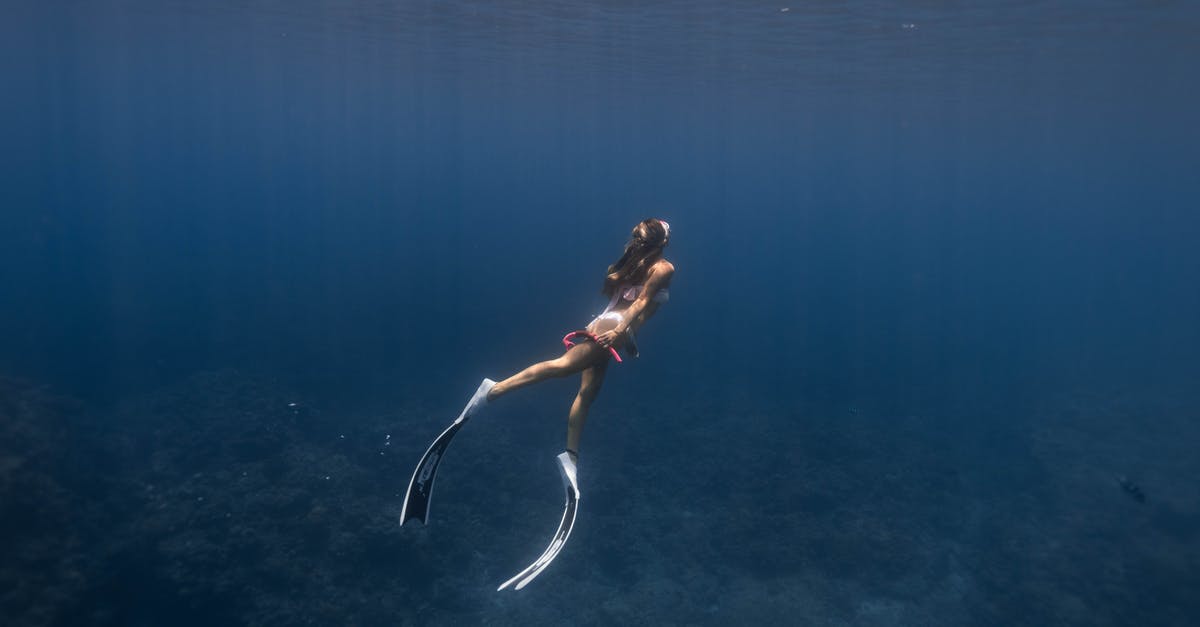 Is it possible to manually release an oxygen mask on airplanes? - Side view full body of anonymous sporty female diver in flippers and mask swimming underwater of blue sea near coral reefs Is it possible to manually release an oxygen mask on airplanes? - Side view full body of anonymous sporty female diver in flippers and mask swimming underwater of blue sea near coral reefs