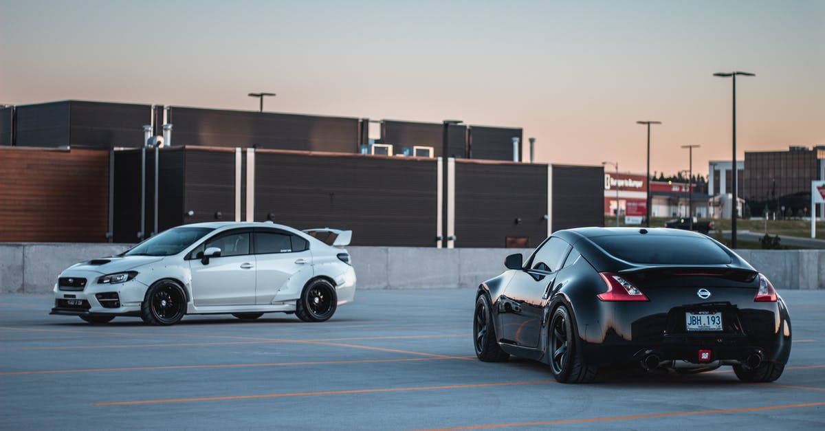 Is it possible to move between the various fifth bases of Fuji? - Black and white race cars on parking lot at sunset Is it possible to move between the various fifth bases of Fuji? - Black and white race cars on parking lot at sunset