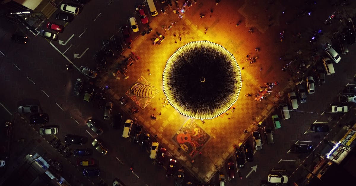 Is it possible to move between the various fifth bases of Fuji? - Aerial view of illuminated merry go round on square near road with various parked cars at night Is it possible to move between the various fifth bases of Fuji? - Aerial view of illuminated merry go round on square near road with various parked cars at night