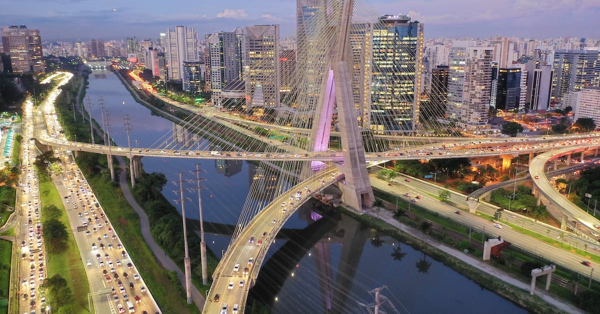 Is it possible to obtain a Brazil visa without confirmed travel plans? (US citizen) - From above of modern bridge crossing river with modern skyscrapers and green trees against cloudy and blue sky Is it possible to obtain a Brazil visa without confirmed travel plans? (US citizen) - From above of modern bridge crossing river with modern skyscrapers and green trees against cloudy and blue sky