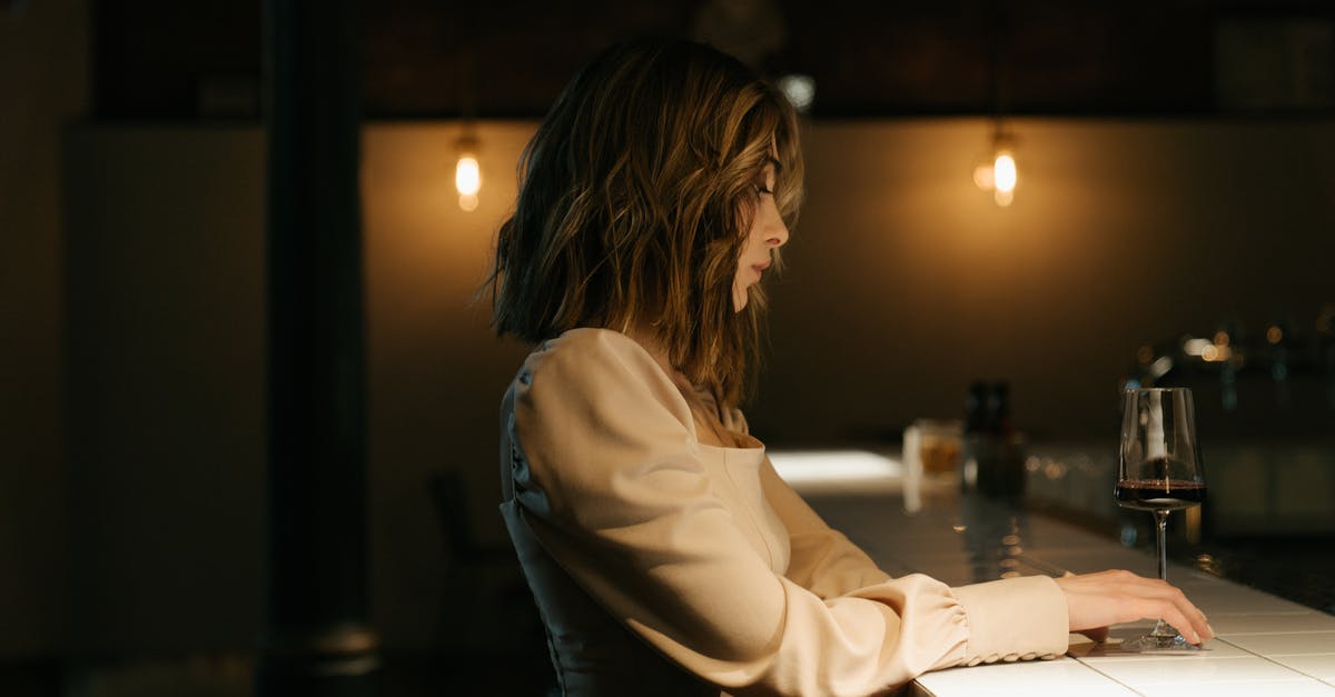 Is it possible to order airag at bars in Mongolia? - Woman in White Long Sleeve Shirt Sitting by the Table Is it possible to order airag at bars in Mongolia? - Woman in White Long Sleeve Shirt Sitting by the Table