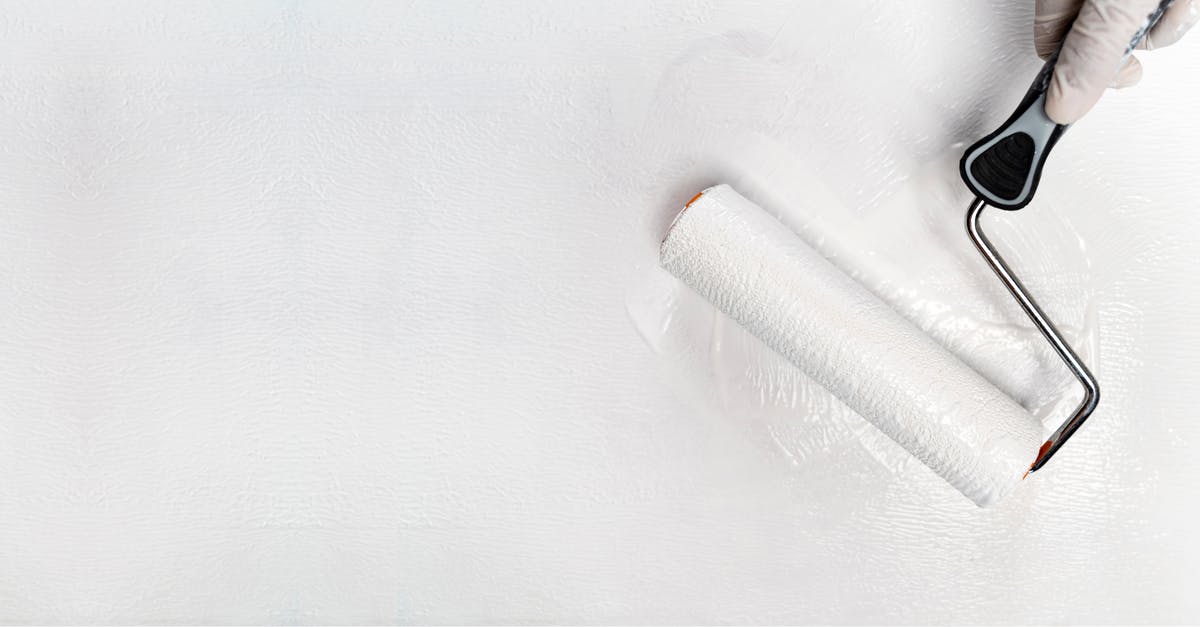 Is it possible to renew my US passport in person at a renewal facility? - Crop anonymous person in latex gloves using roller brush with white color while painting wall during home renovation Is it possible to renew my US passport in person at a renewal facility? - Crop anonymous person in latex gloves using roller brush with white color while painting wall during home renovation