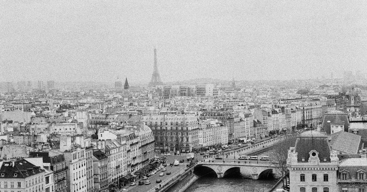 Is it possible to stay overnight in Paris for a flight in London? - Grayscale Photo of City Buildings
