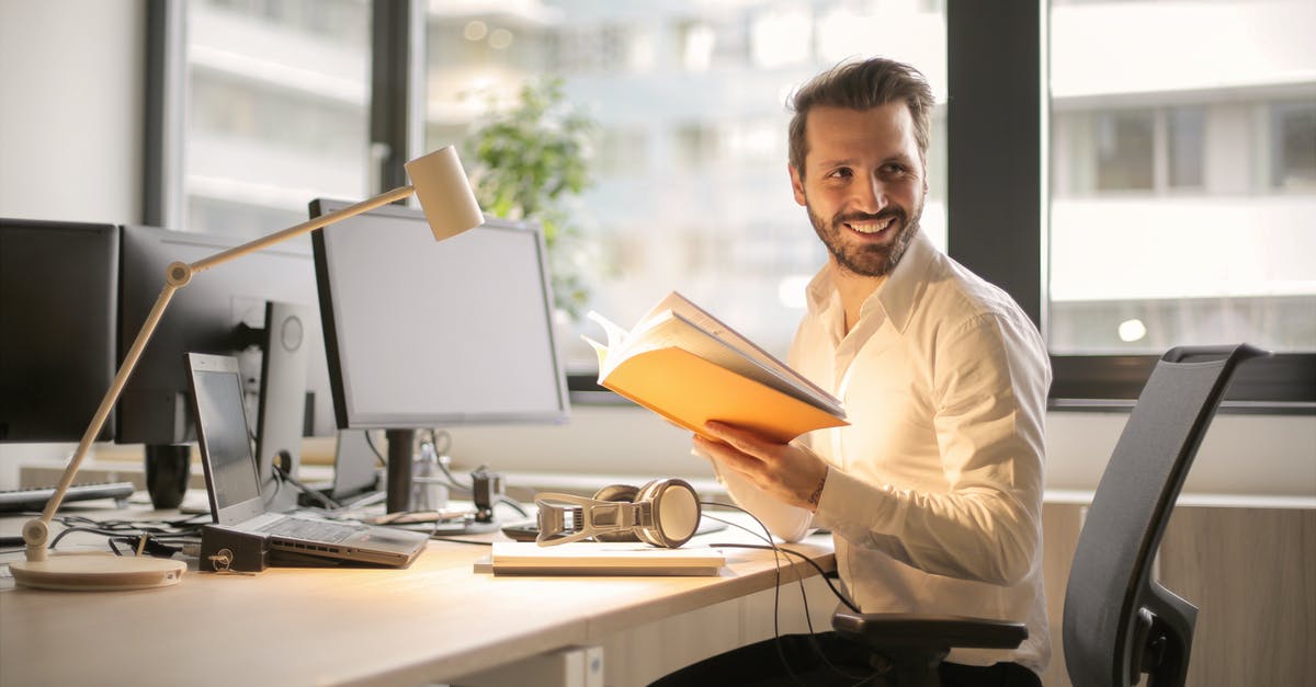 Is it possible to take a desktop PC as carry-on luggage? - Photo of Man Holding a Book Is it possible to take a desktop PC as carry-on luggage? - Photo of Man Holding a Book