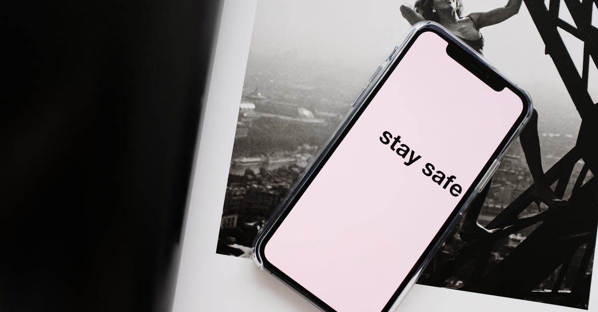 Is it possible to take a photo of Elizabeth Tower (Big Ben) from an airplane window? - From above of cellphone pale pink screen with STAY SAFE inscription put on open magazine with photo of cheerful woman climbing metal tower in city