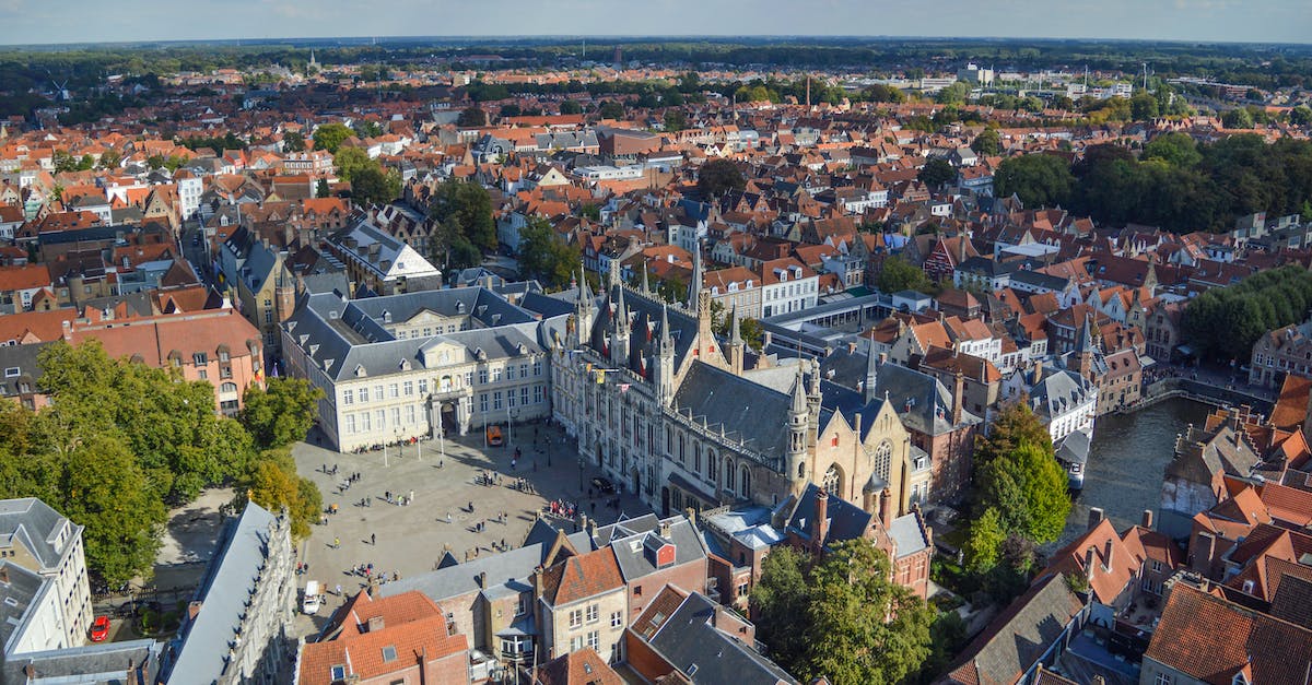 Is it possible to travel on river/canal from Bruges, Belgium to some point on the Rhine? - From above of historical Bruges City Hall located on Burg Square near canal and aged buildings on sunny day Is it possible to travel on river/canal from Bruges, Belgium to some point on the Rhine? - From above of historical Bruges City Hall located on Burg Square near canal and aged buildings on sunny day