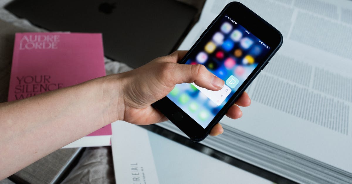 Is it possible to use hostel booking for a UK Standard Visitor visa application or must it be a hotel? [duplicate] - Crop unrecognizable person touching smartphone screen and having open encyclopedia