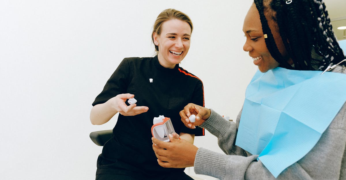 Is it possible to visit the service tunnel of the Channel Tunnel? - Cheerful young female dentist discussing tooth structure with client Is it possible to visit the service tunnel of the Channel Tunnel? - Cheerful young female dentist discussing tooth structure with client