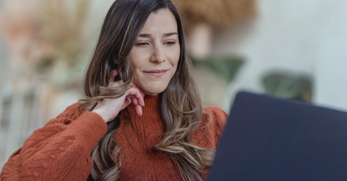 Is it possible to work remotely as a UK employee from France while on a long holiday? [closed] - Smiling woman browsing laptop for remote job