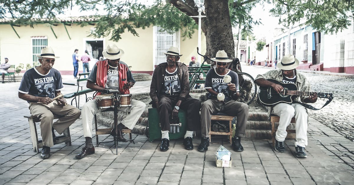 Is it practical to live in Stockholm's inner city while studying in Kista? [closed] - Adult ethnic male street band performing song on street