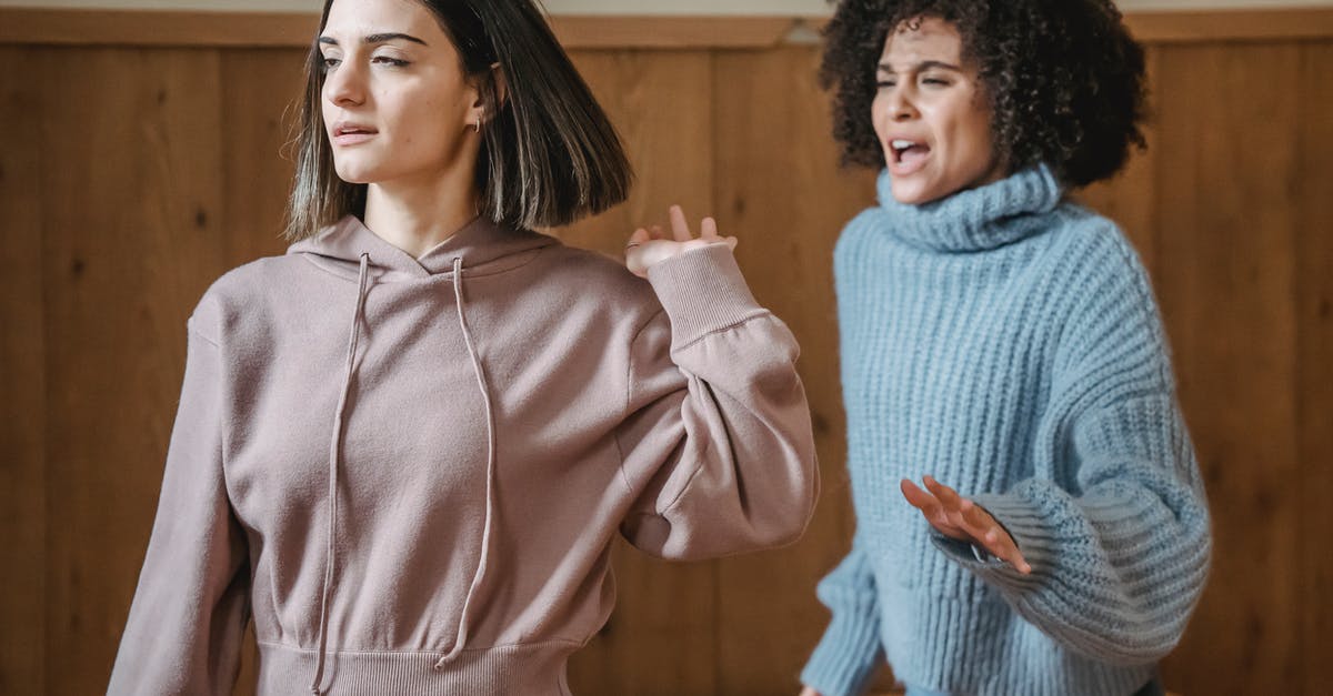 Is it rude to speak Swedish in Norway? - Mad African American female in warm sweater screaming at irritated female while having argument in light room with wooden walls Is it rude to speak Swedish in Norway? - Mad African American female in warm sweater screaming at irritated female while having argument in light room with wooden walls